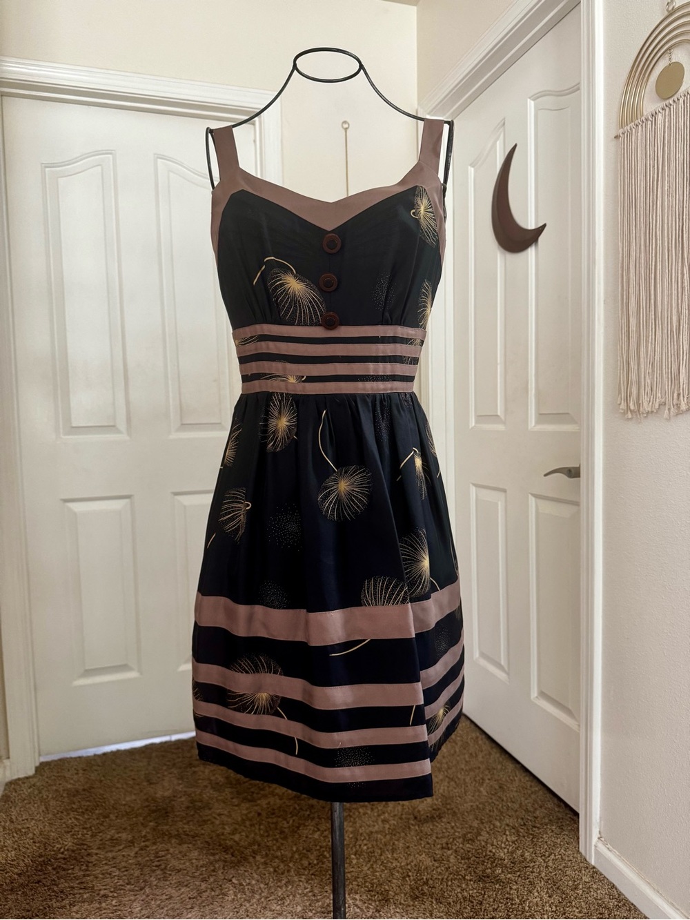 Retro-Inspired Black Mini Dress with Taupe Trim and Gold Dandelion Print